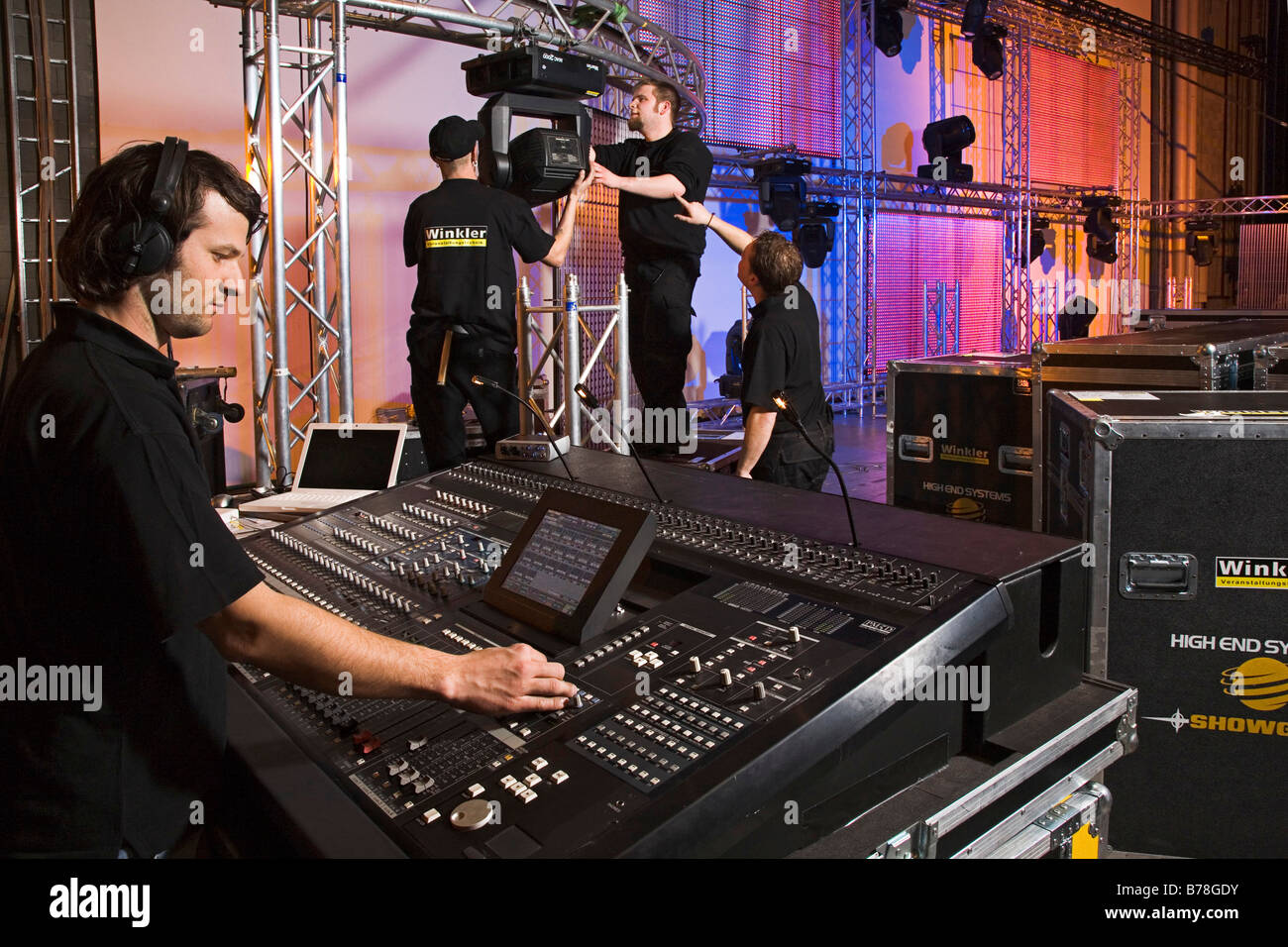 Employee of the event technology company, Winkler, during the setting up of sound and light equipment on the stage in the congr Stock Photo