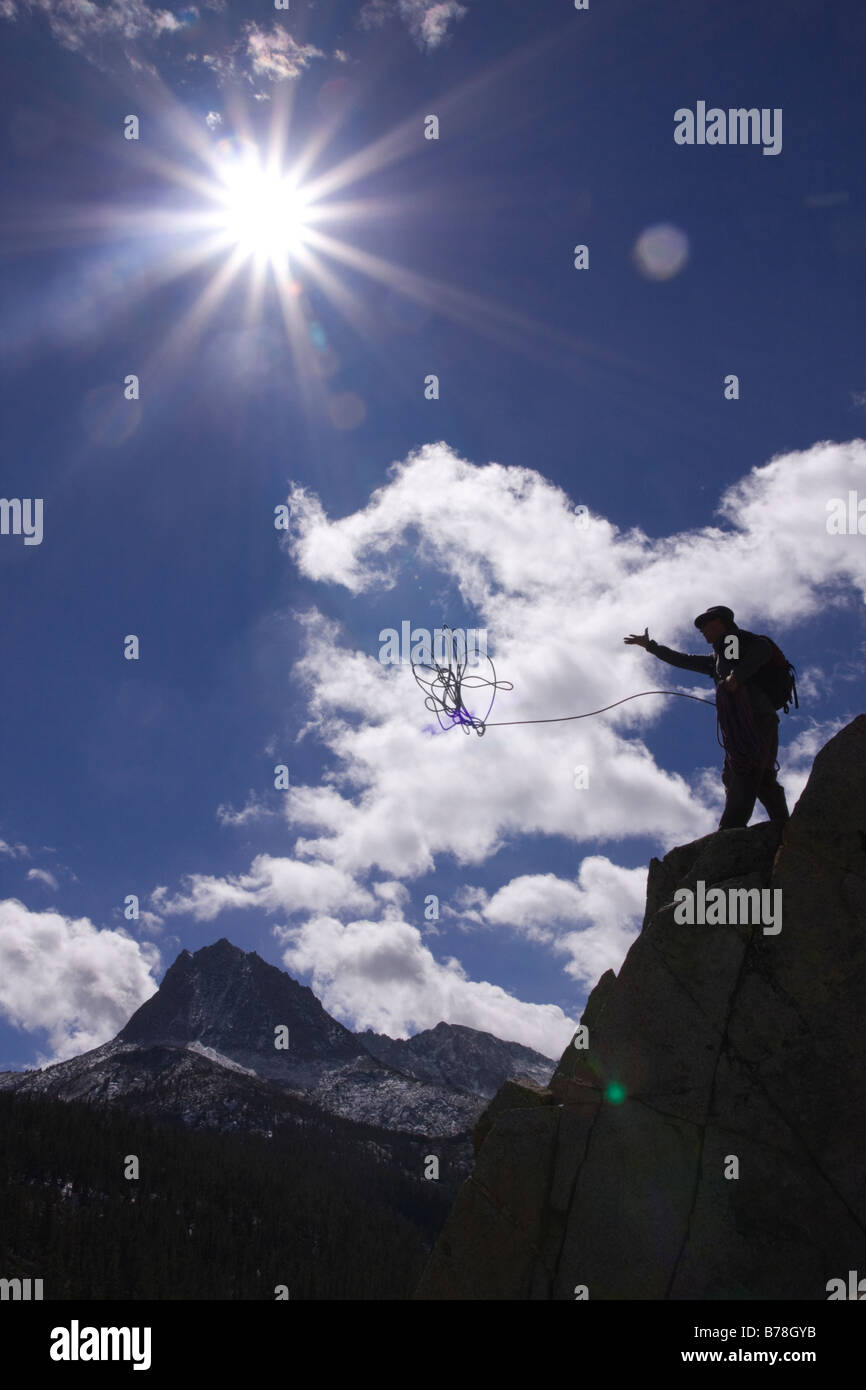 Silhouette of a man holding a climbing rope on a cliff while rock climbing near South Lake in the Sierra Mountains of California Stock Photo