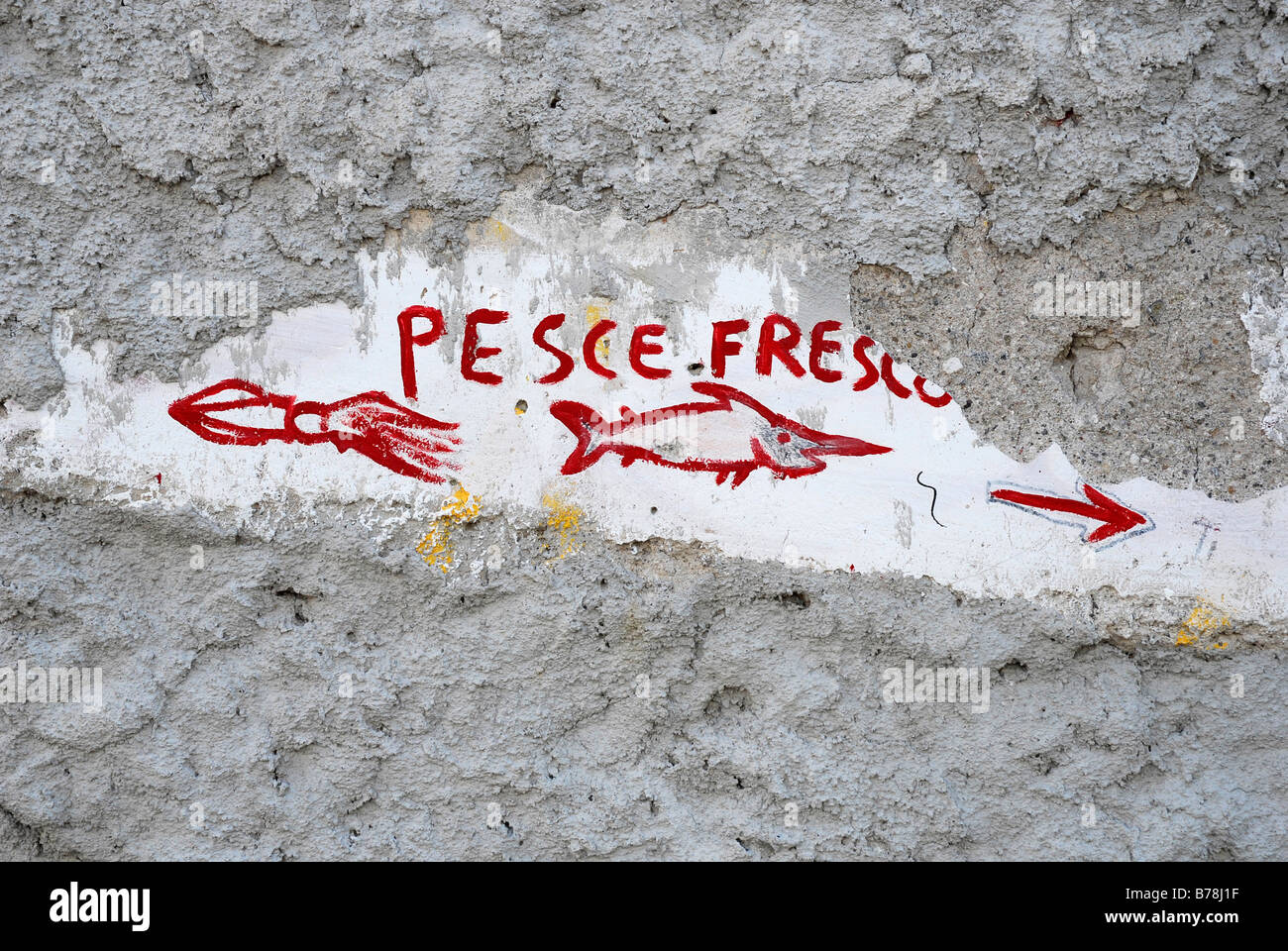 Red graffiti on a gray wall, pesce fresco, fresh fish, advertising for a fish shop in the city of Lipari on Lipari Island, Aeol Stock Photo