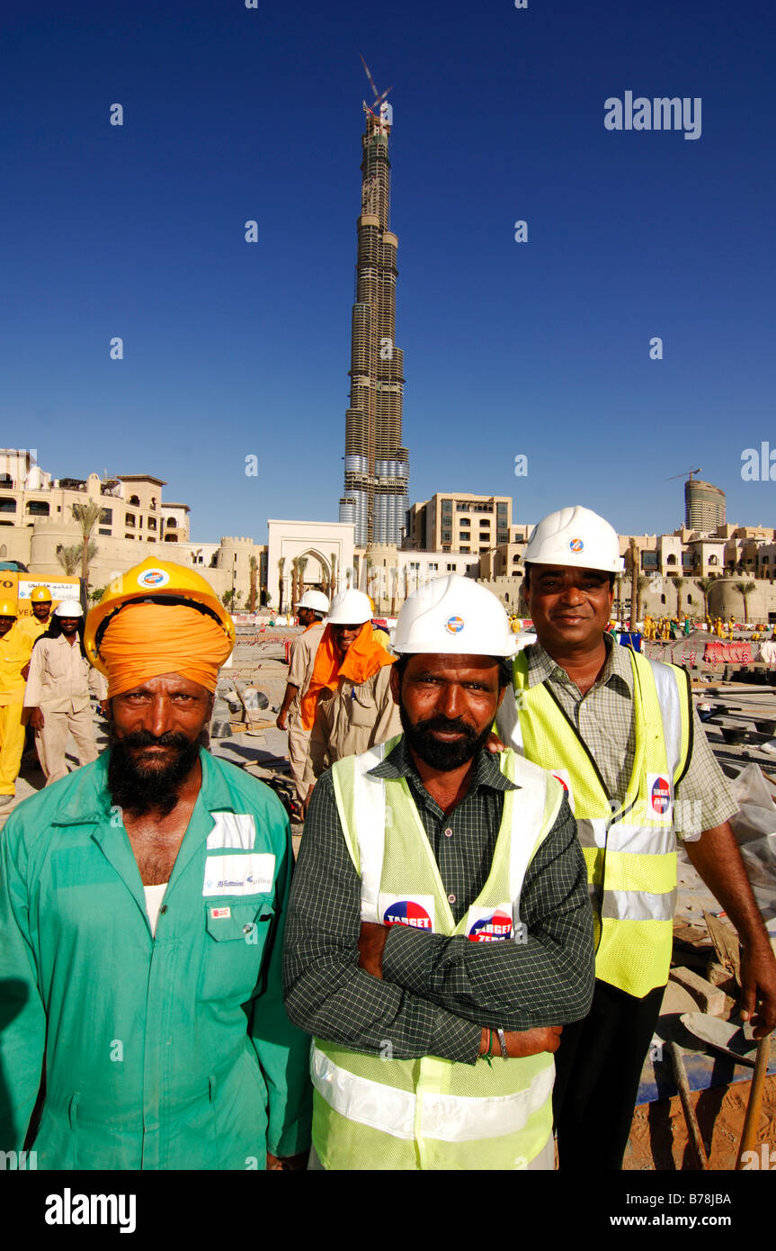 Construction workers in front of the highest skyscaper in the world, Burj Dubai, Dubai, United Arab Emirates, UAE, Middle East Stock Photo
