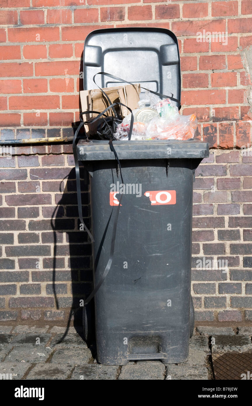 Garbage Can in front of brick wall Stock Photo Alamy