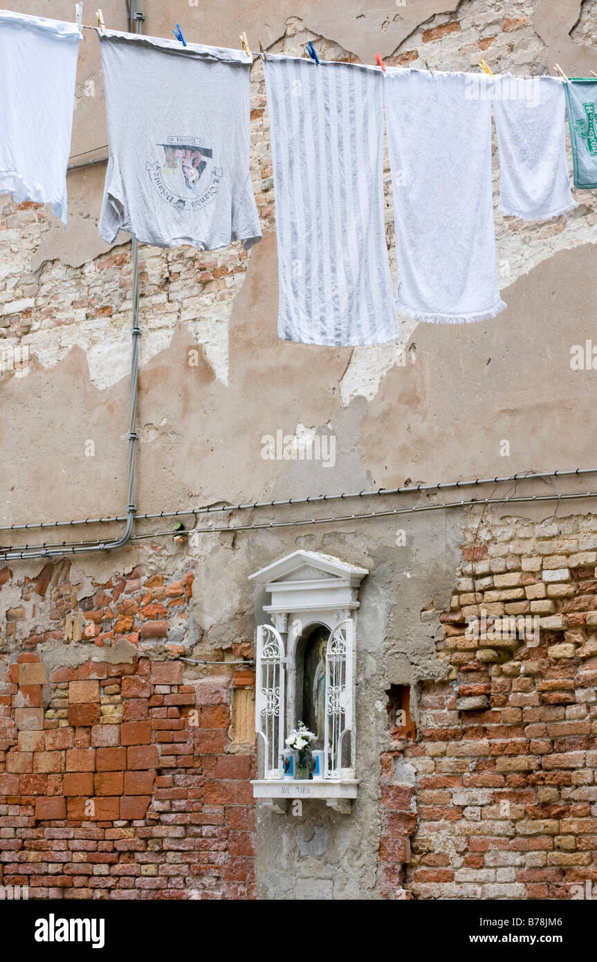 Italy, Venice, Old brick wall, Madonna image, clothesline Stock Photo