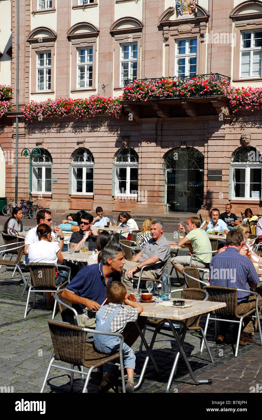 Bar café restaurant terrace, guests, on the Marktplatz Square in sommer, in the back the facade of the town hall, historic cent Stock Photo