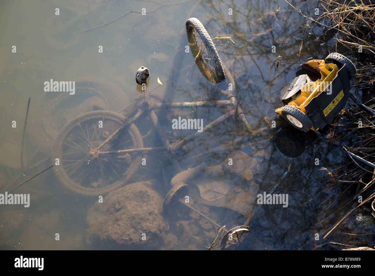 Old bike dumped in river Stock Photo
