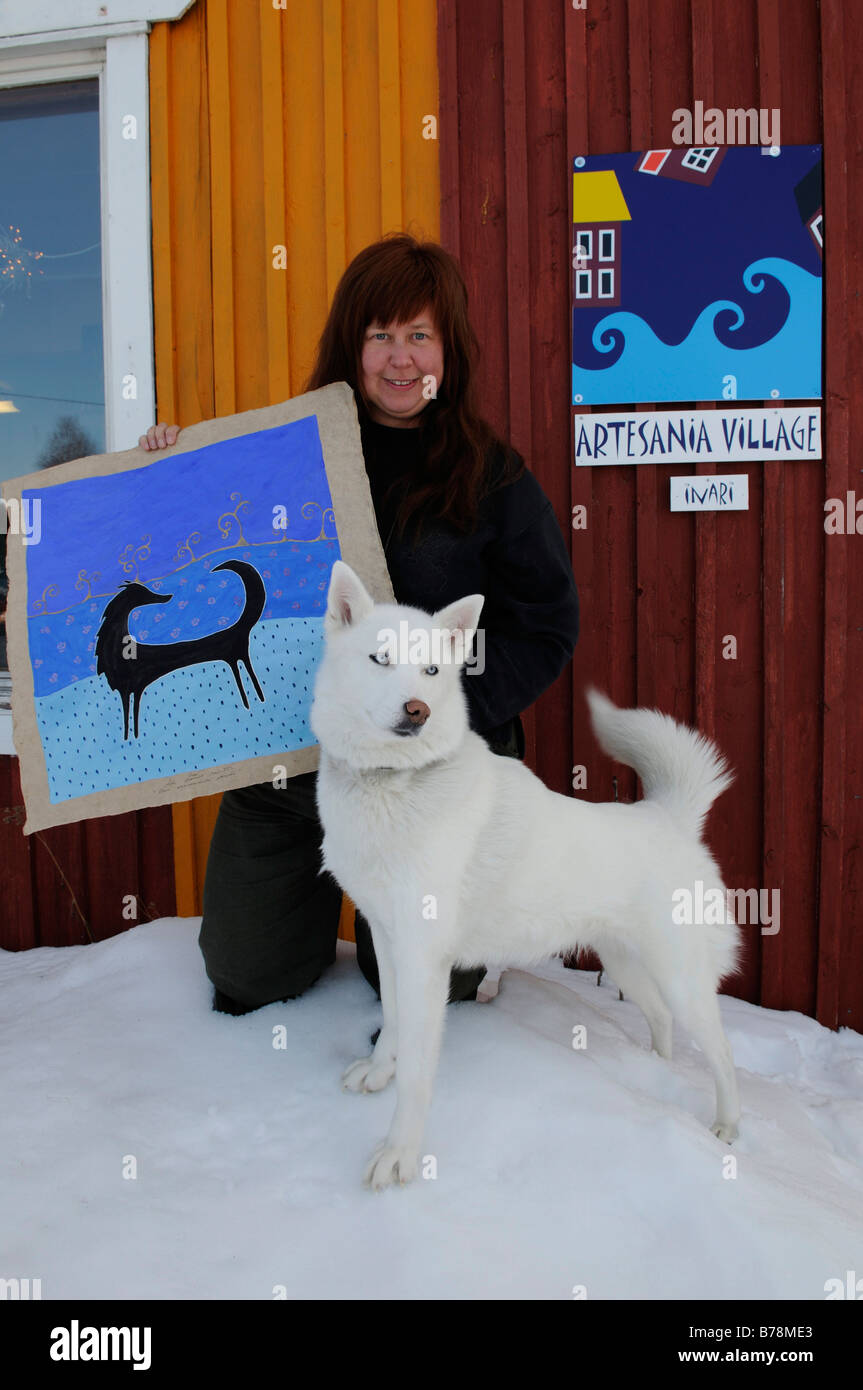 Satu Maarit Natunen, Sami artisan craftwork artist with husky and painting in Inari, Lapland, Finland, Europe Stock Photo