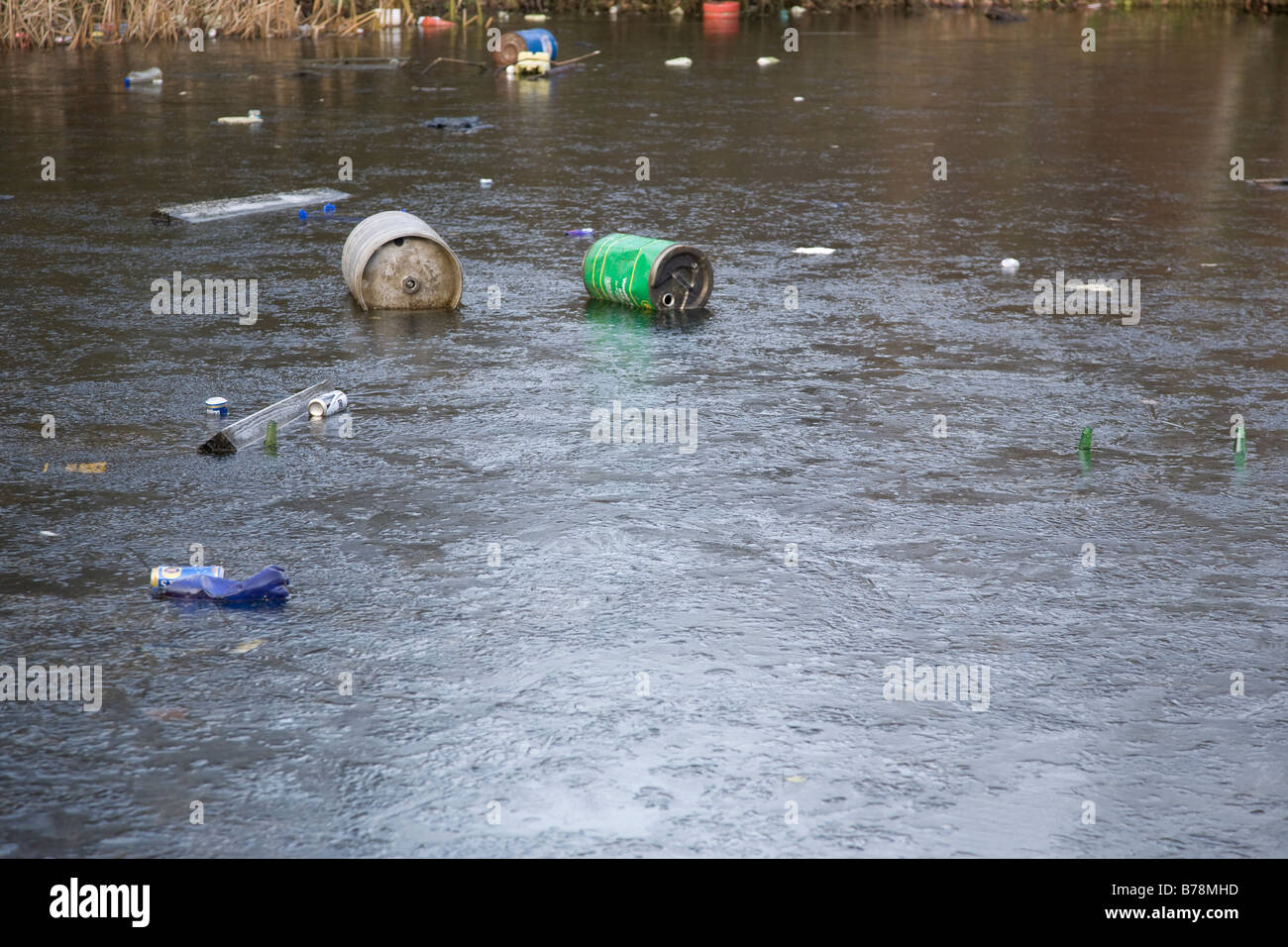 frozen lake with rubbish floating Stock Photo