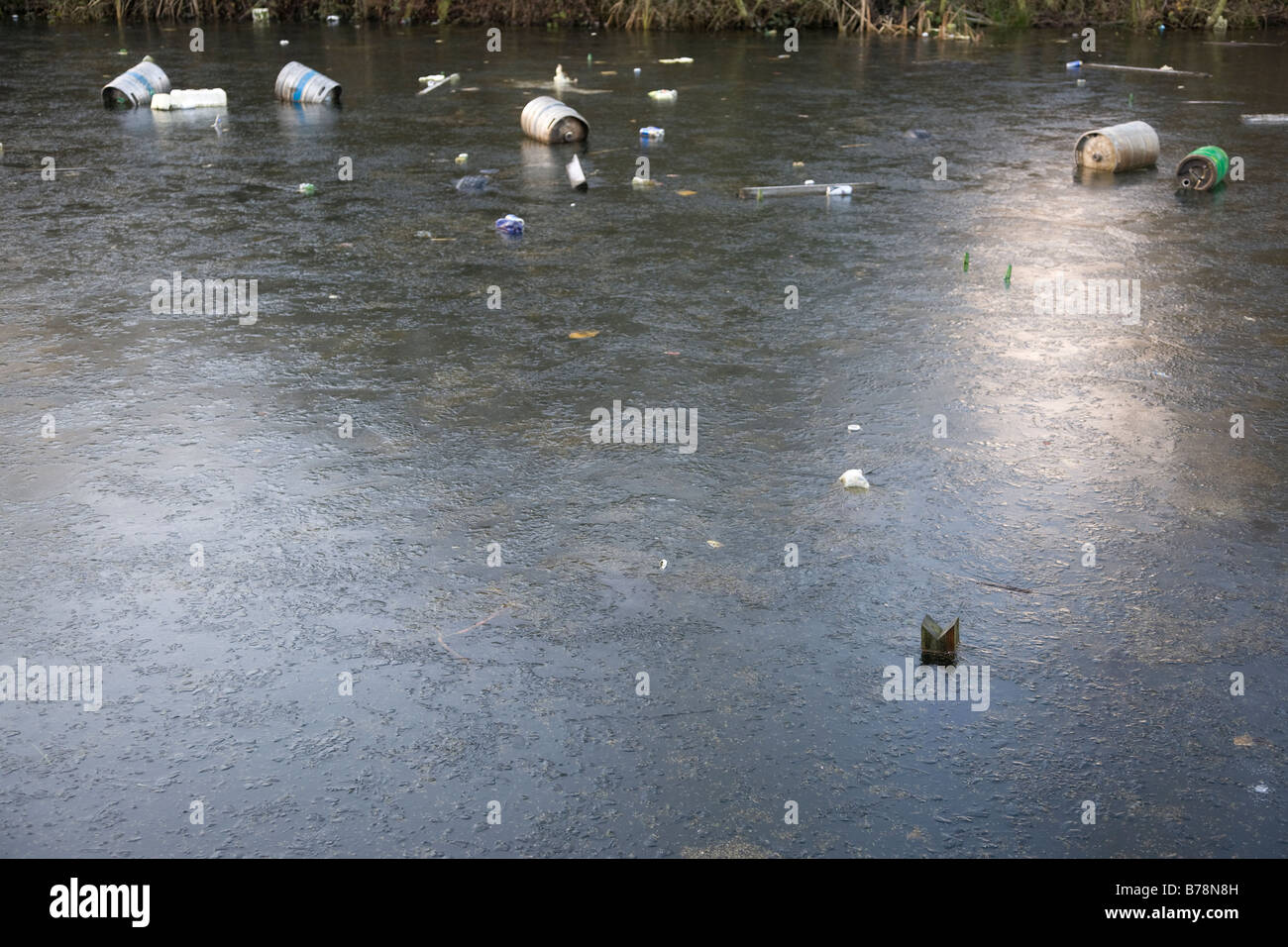 frozen lake with rubbish floating Stock Photo