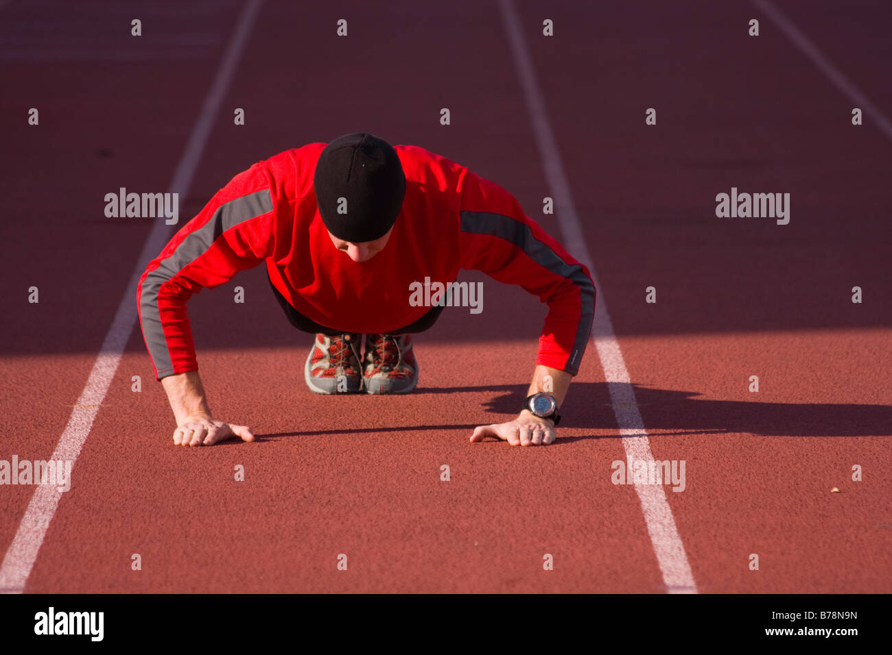 A man doing a pushup on a track before running in Reno in Nevada Stock Photo