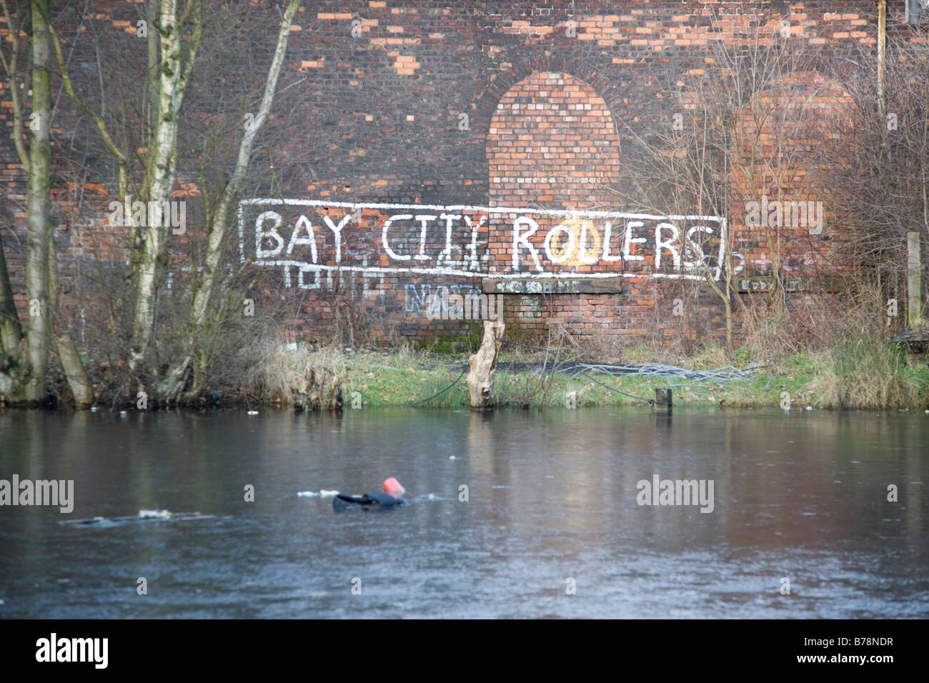 frozen lake with rubbish floating and 70's graffiti, Bay City Rollers Stock Photo