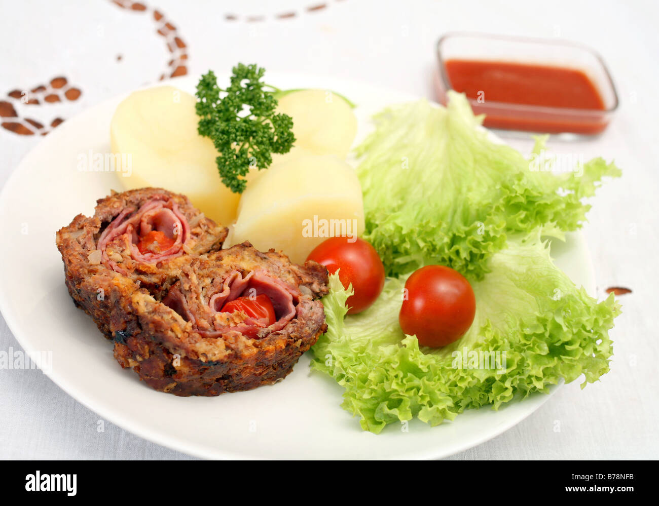 Beef roulade containing ham and cherry tomatoes,served with lettuce