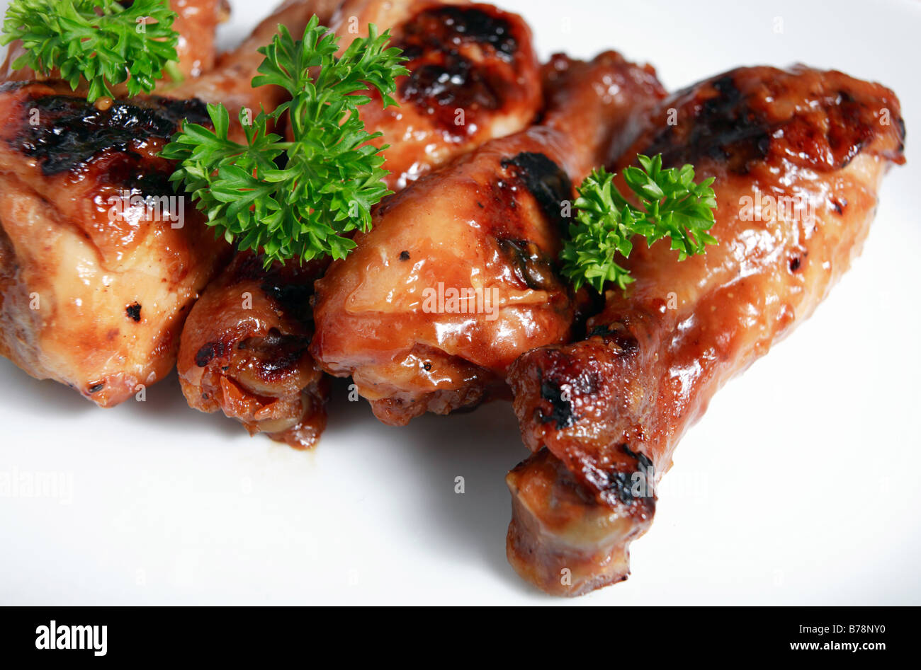 Grilled chicken drumsticks glazed with a chinesestyle marinade Stock
