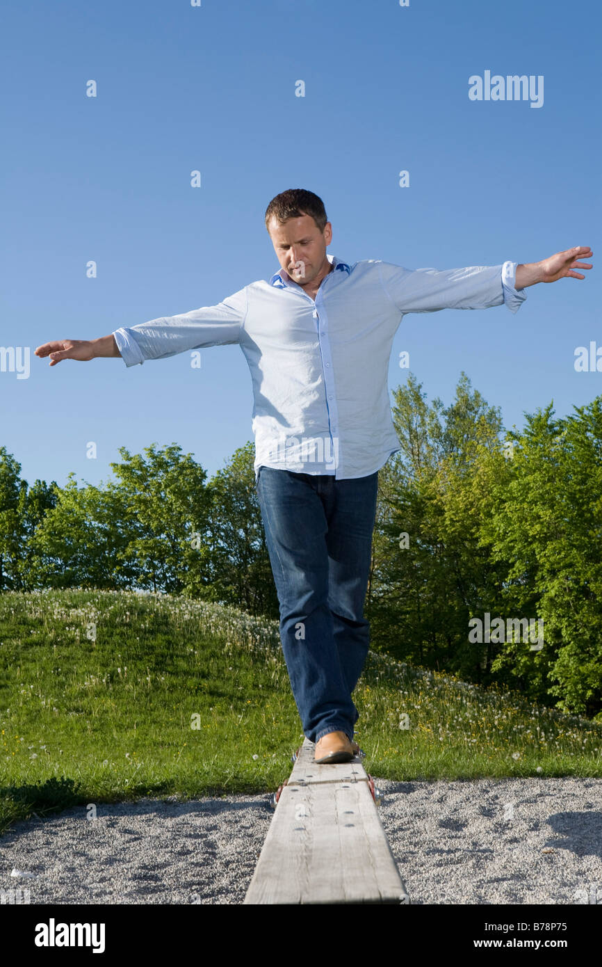 Men Balancing Young man balancing on boardwalk in a playground Stock Photo - Alamy