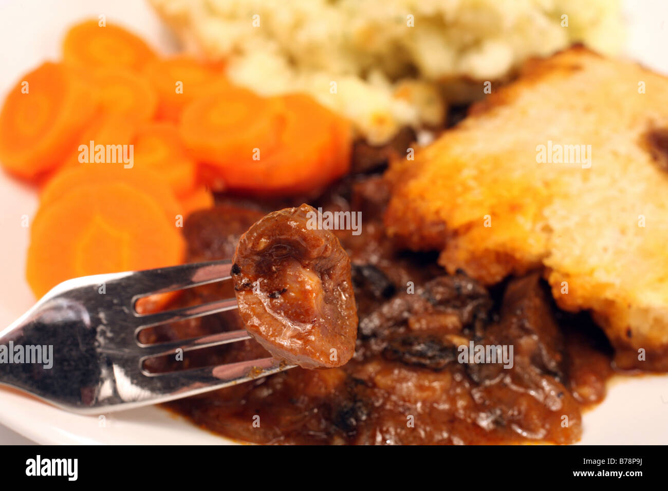 Eating a piece of kidney from a suetcrust topped pie Stock Photo Alamy