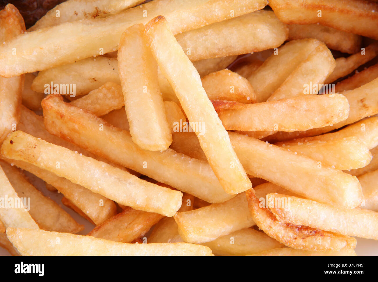 Closeup view of a pile of salted potato chips or French fries Stock