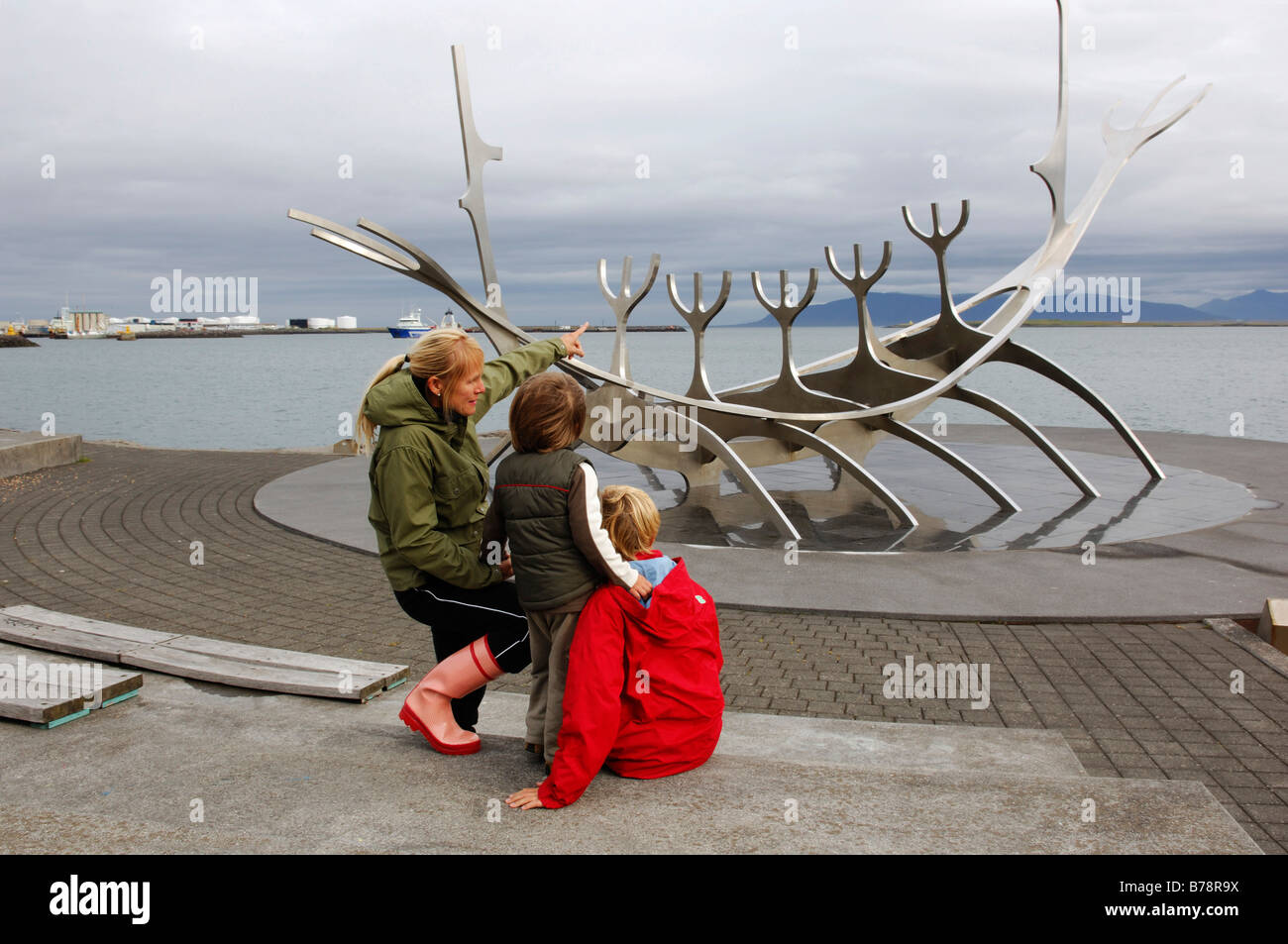 Woman and two children observing Solfarer, Viking ship made from stainless steel, Reykjavik, Iceland, Europe Stock Photo
