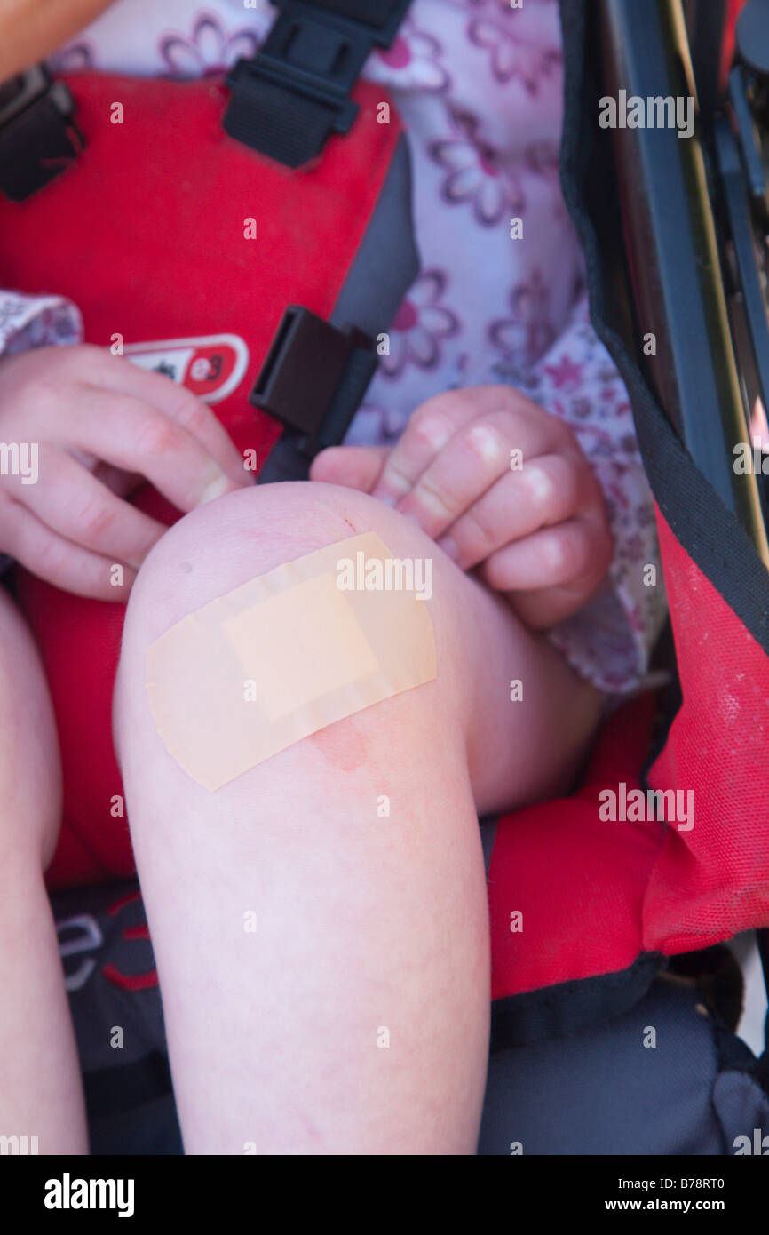 Sticking plaster on little girl's knee Stock Photo