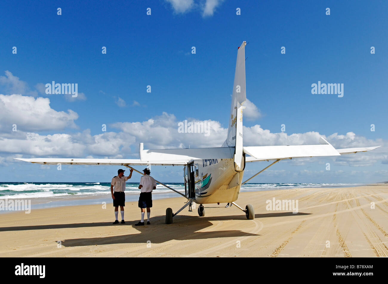 Pilotes and plane on the 75-Mile Beach, Fraser Island, Queensland, Australia Stock Photo