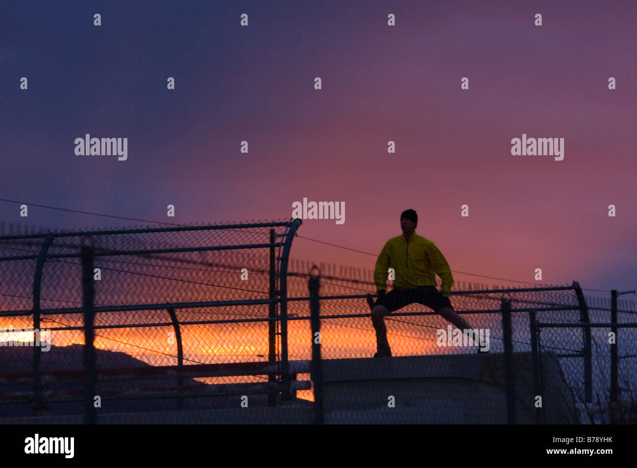 A man stretching before running at sunset in Reno in Nevada Stock Photo