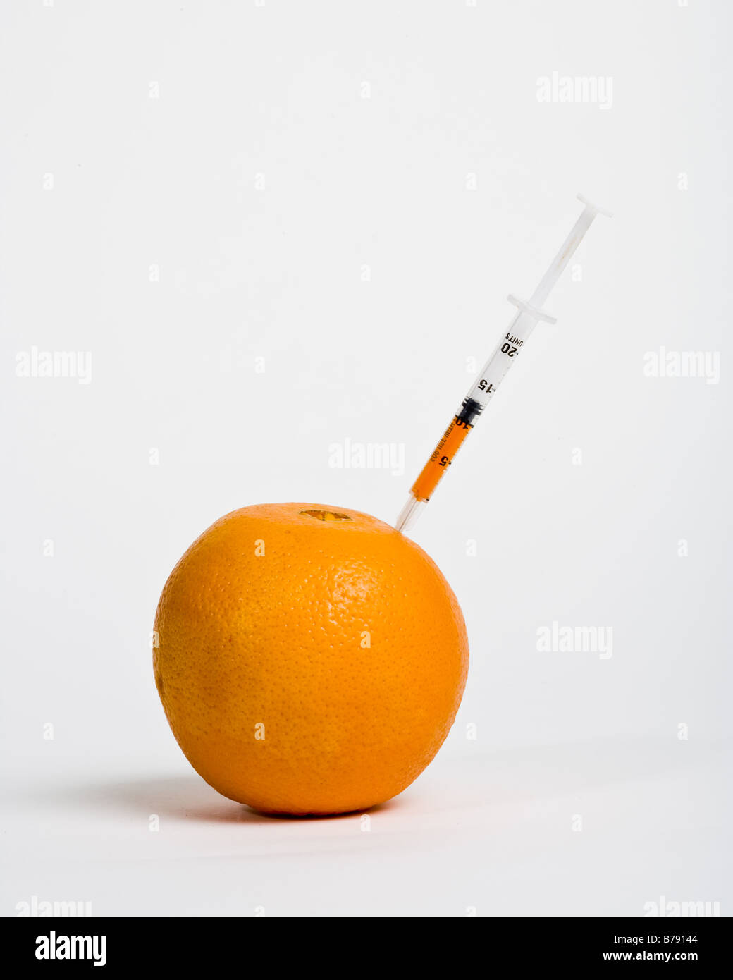 An orange being injected Stock Photo