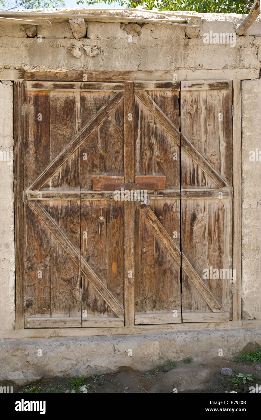 An old wooden doorway on a mud house in Skardu in Pakistan Stock Photo