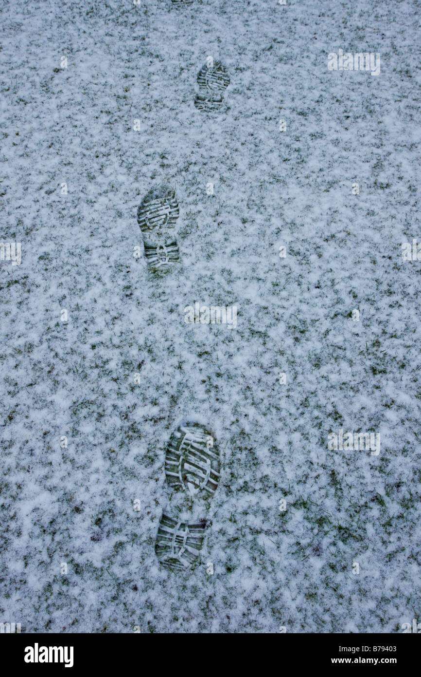 Footprints in snow on grass Stock Photo