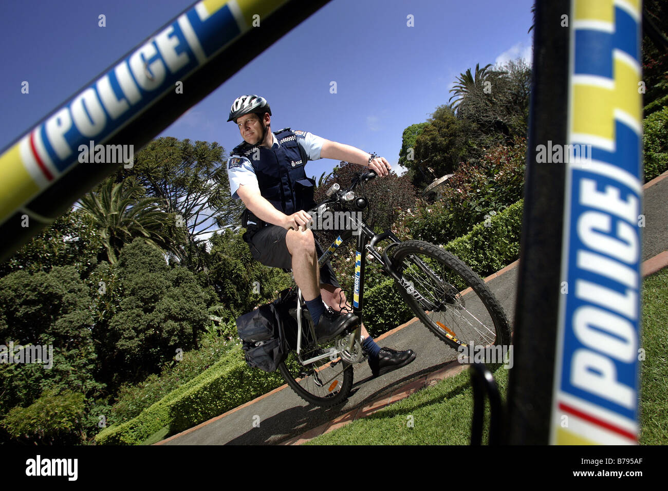 police officer on official issue bike with flashing lights and siren in Nelson New Zealand Stock Photo