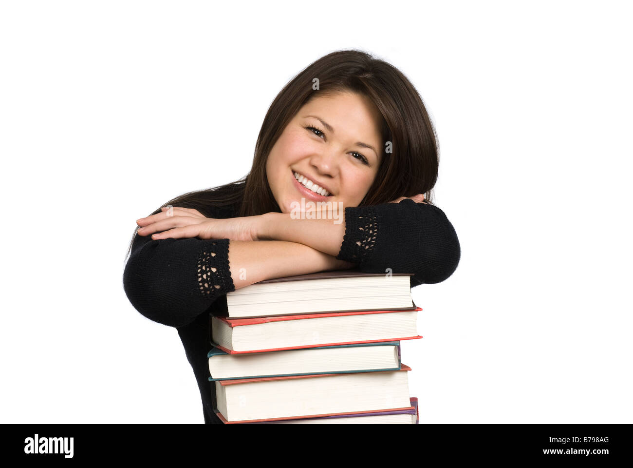 A teenage student rests on her stack of books Stock Photo - Alamy