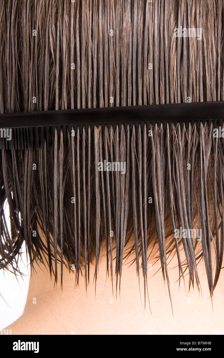 A woman combs her hair after a shower Stock Photo Alamy