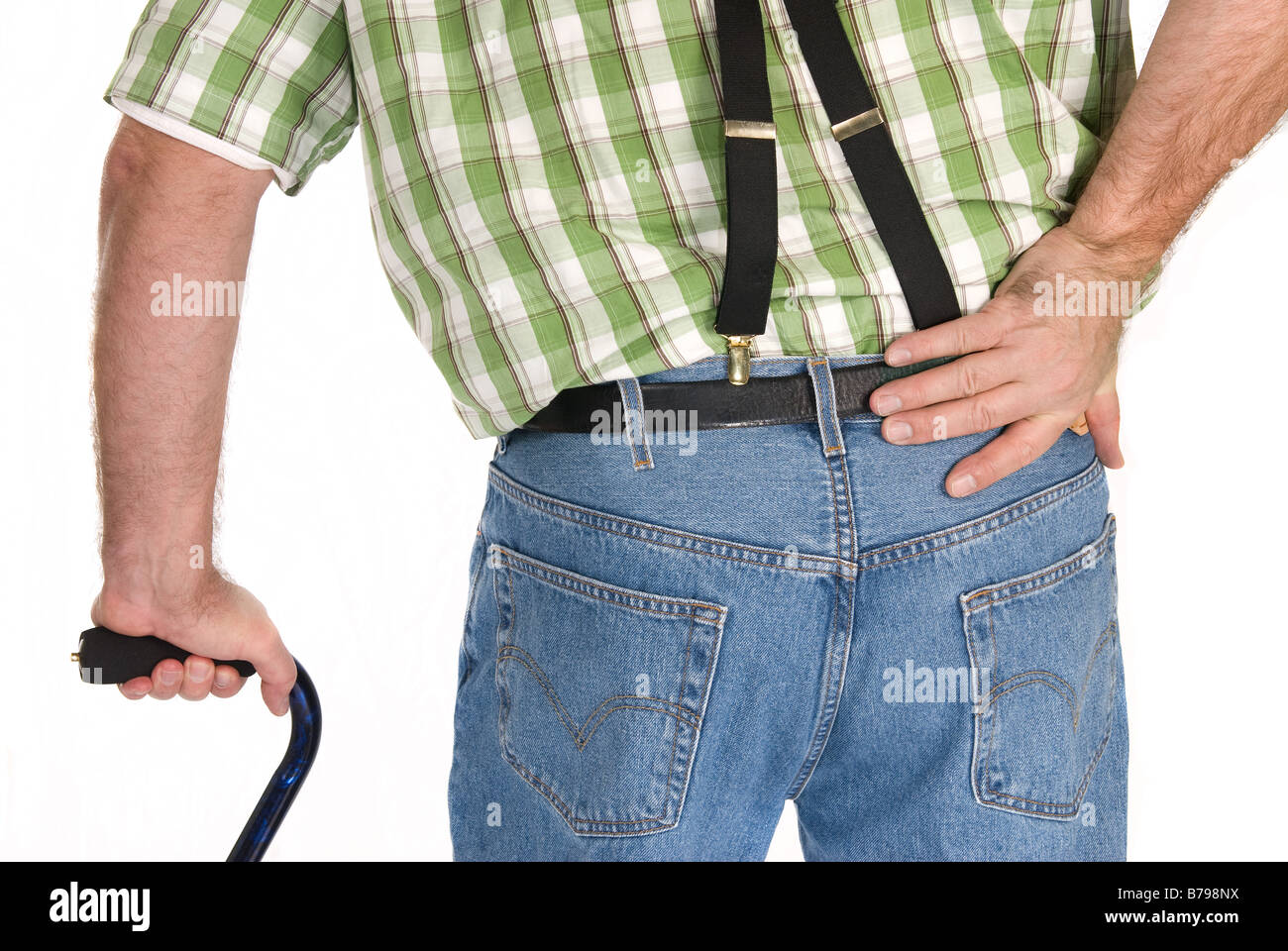 Backside of an adult walking with a cane Stock Photo