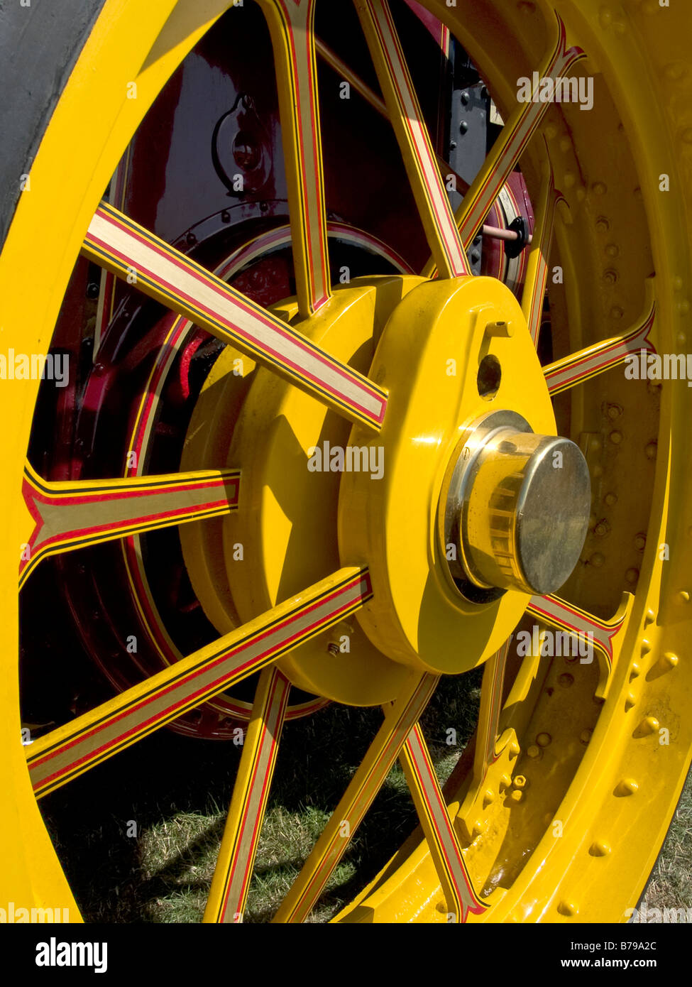 a detail of a traction engine wheel with its polished brass hub and 'lined out' paintwork Stock Photo