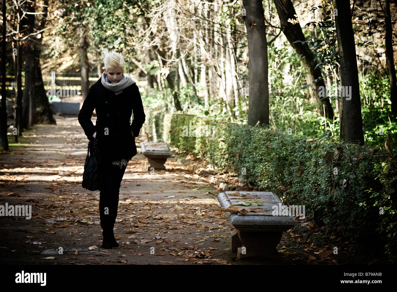 Young woman taking a walk in the park Stock Photo - Alamy
