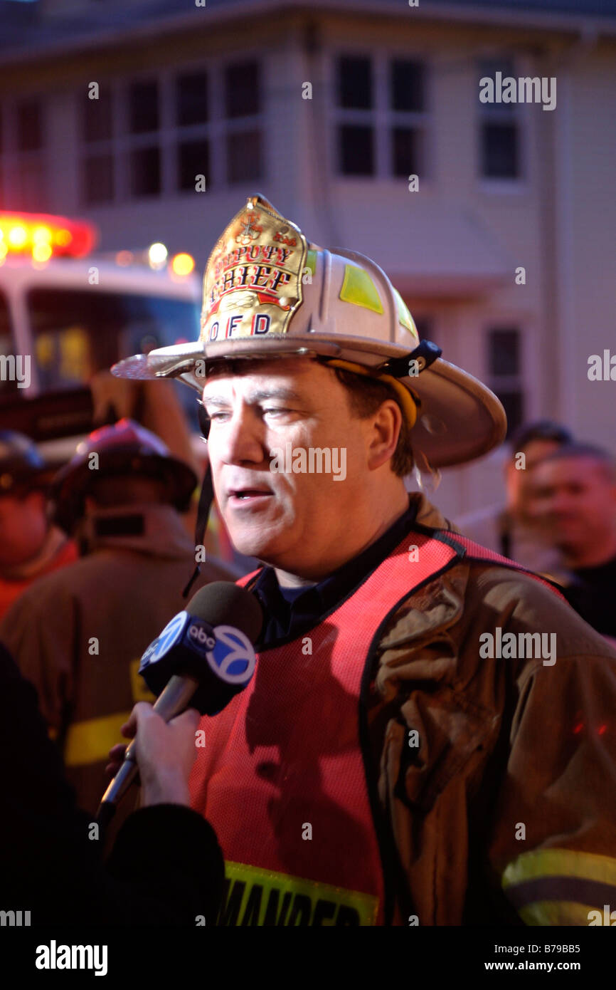 Fire chief being interviewed by media Stock Photo