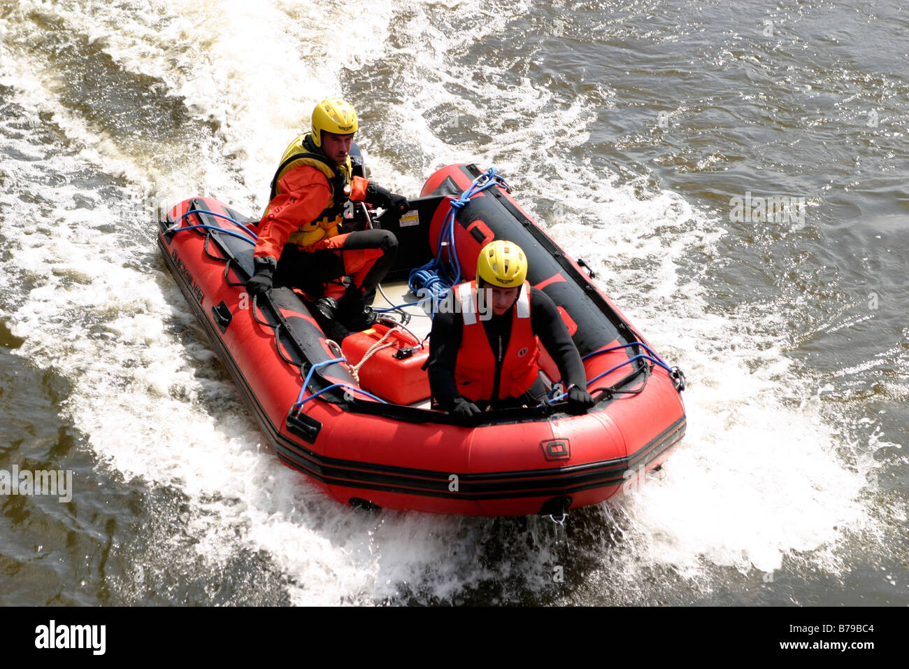 Fire Fighters in inflatable boat Stock Photo - Alamy