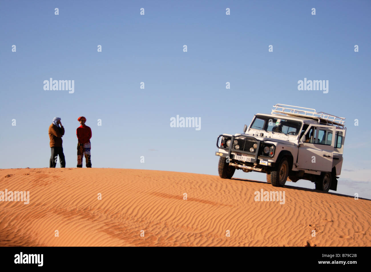 People and off-road vehicle  in the dunes of Erg Chebbi, Merzouga, Morocco Stock Photo