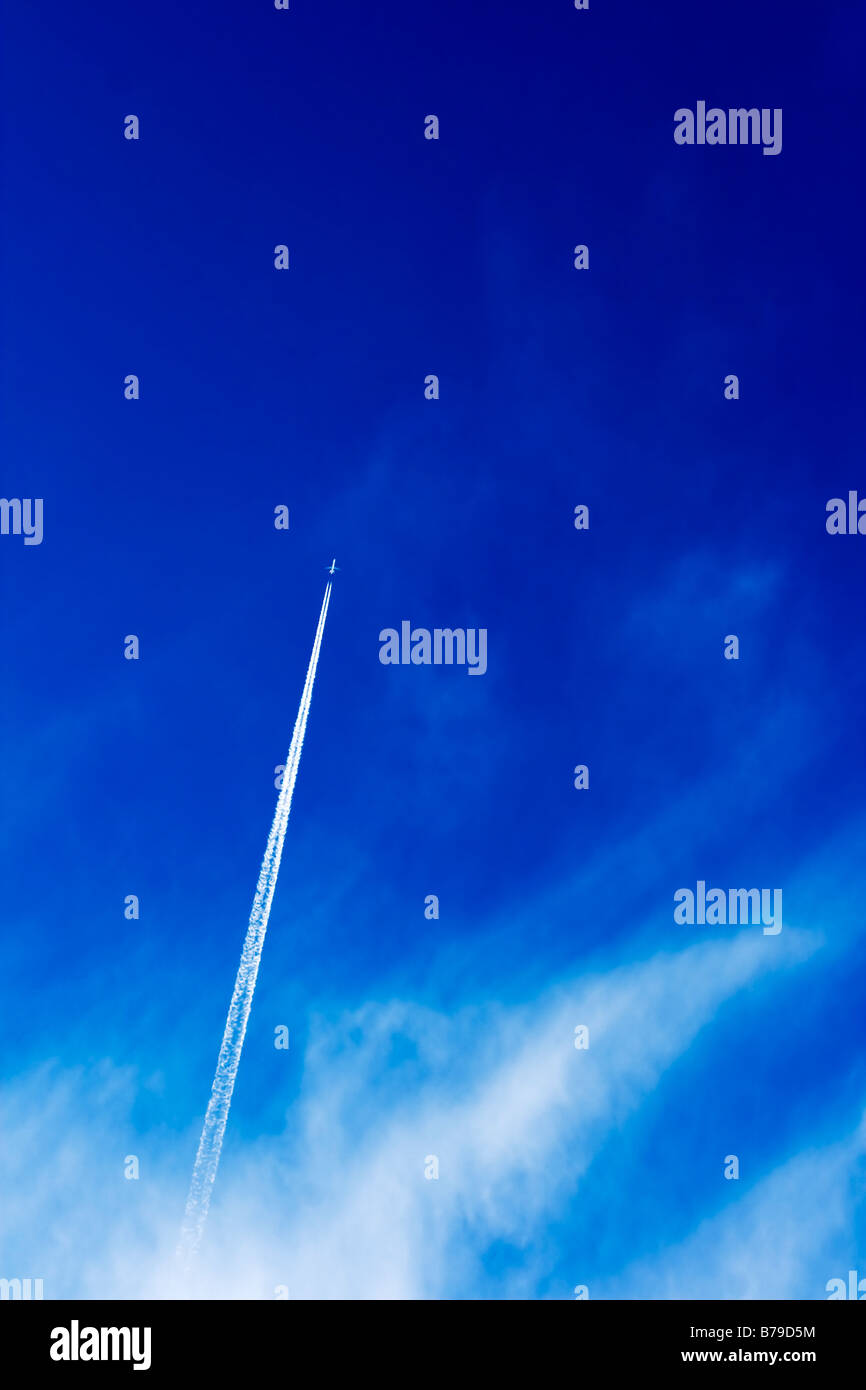 airplane flying from the clouds on a blue sky Stock Photo - Alamy