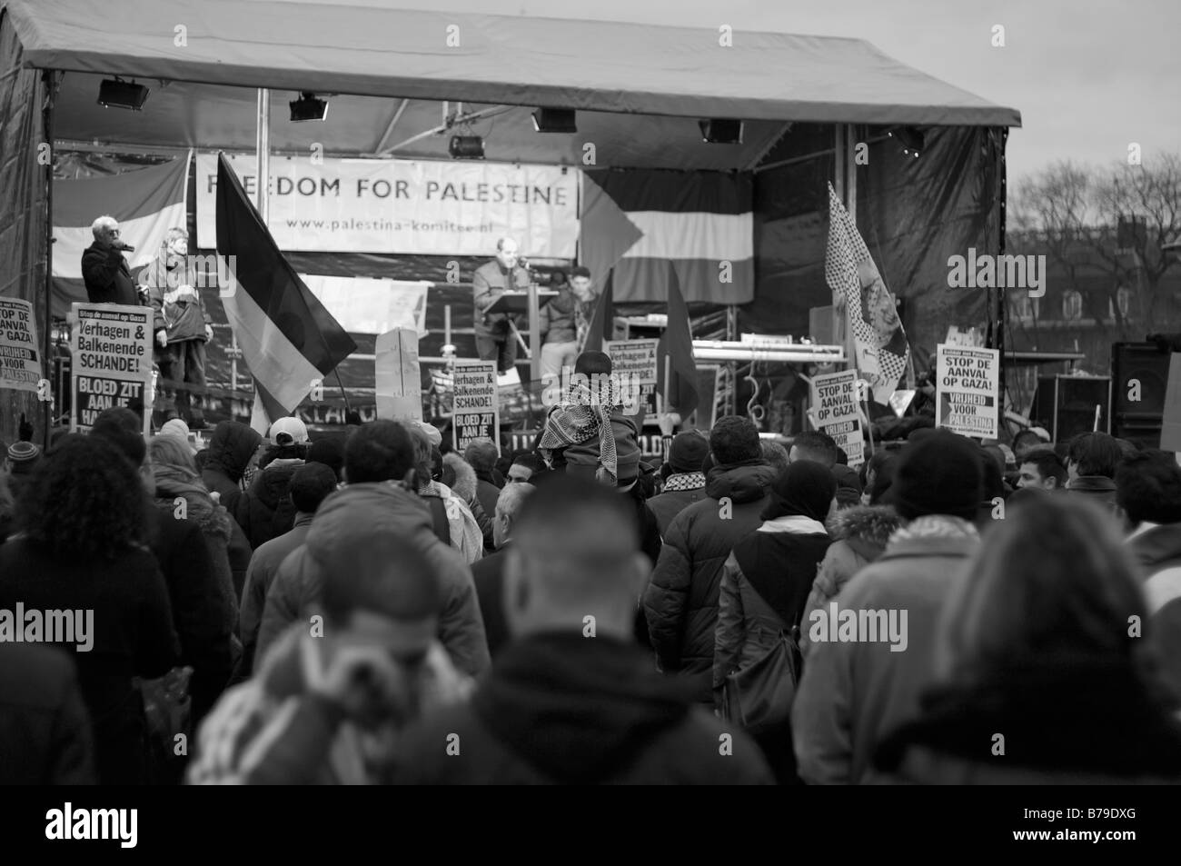 Thousands gather in Amsterdam to protest the 2009 violence in Gaza.  A boy watches on top of his father's shoulders. Stock Photo