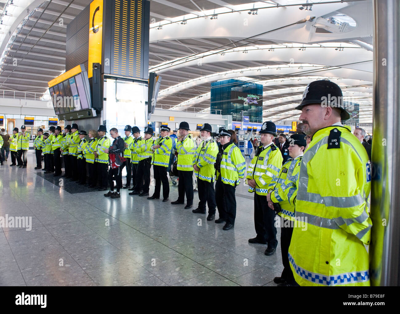 Police officers cordoning off an area inside Heathrow Airport Terminal