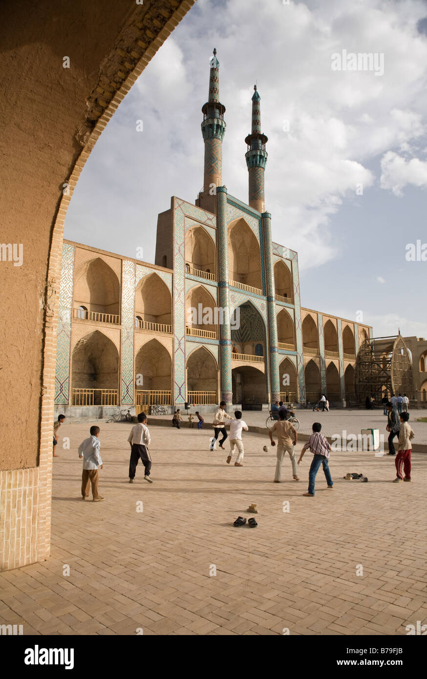 A game a street football takes place in front of Takyeh Amir Chakhmagh in Yazd Stock Photo
