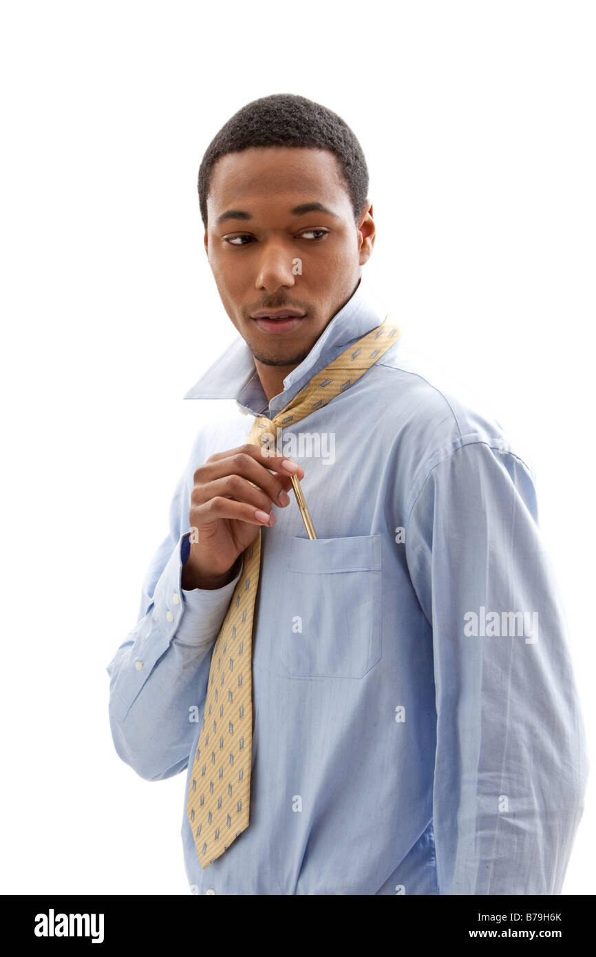 Handsome African American male in blue shirt and yellow tie putting pen