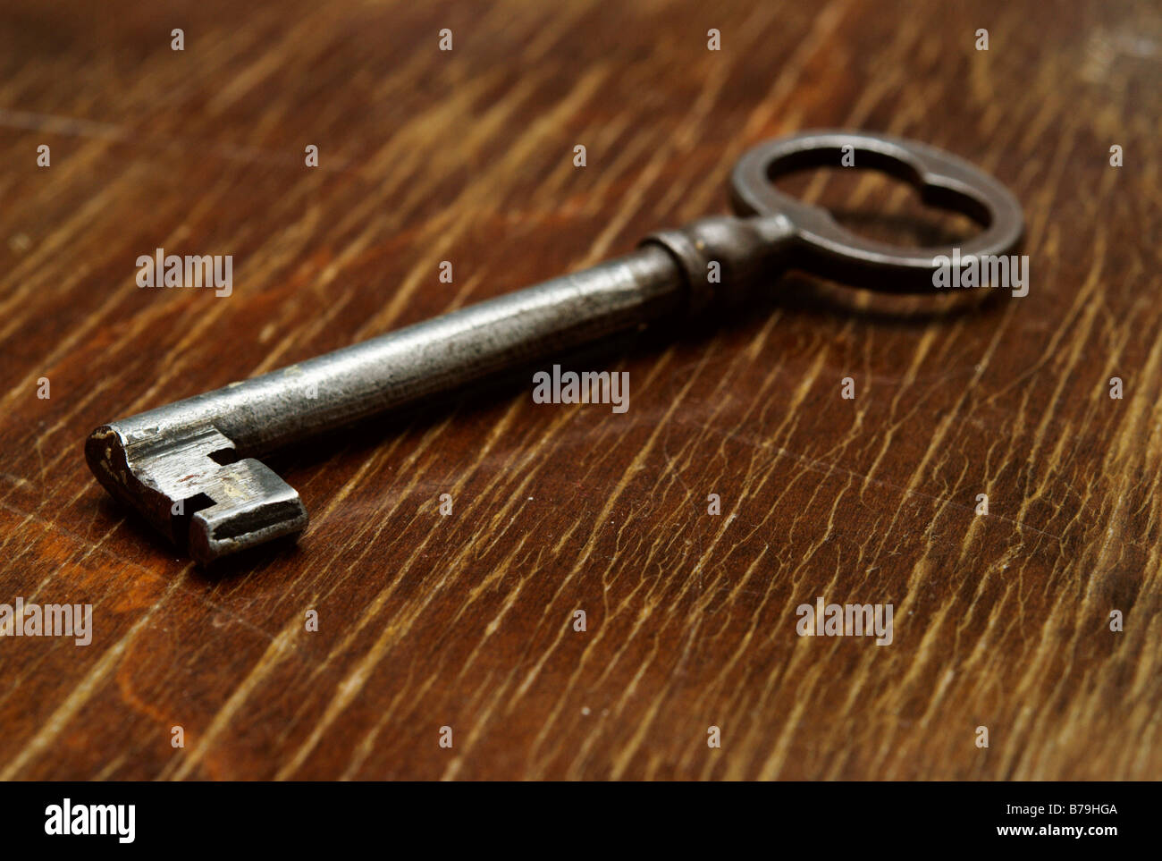 Old key on wooden tabletop Stock Photo