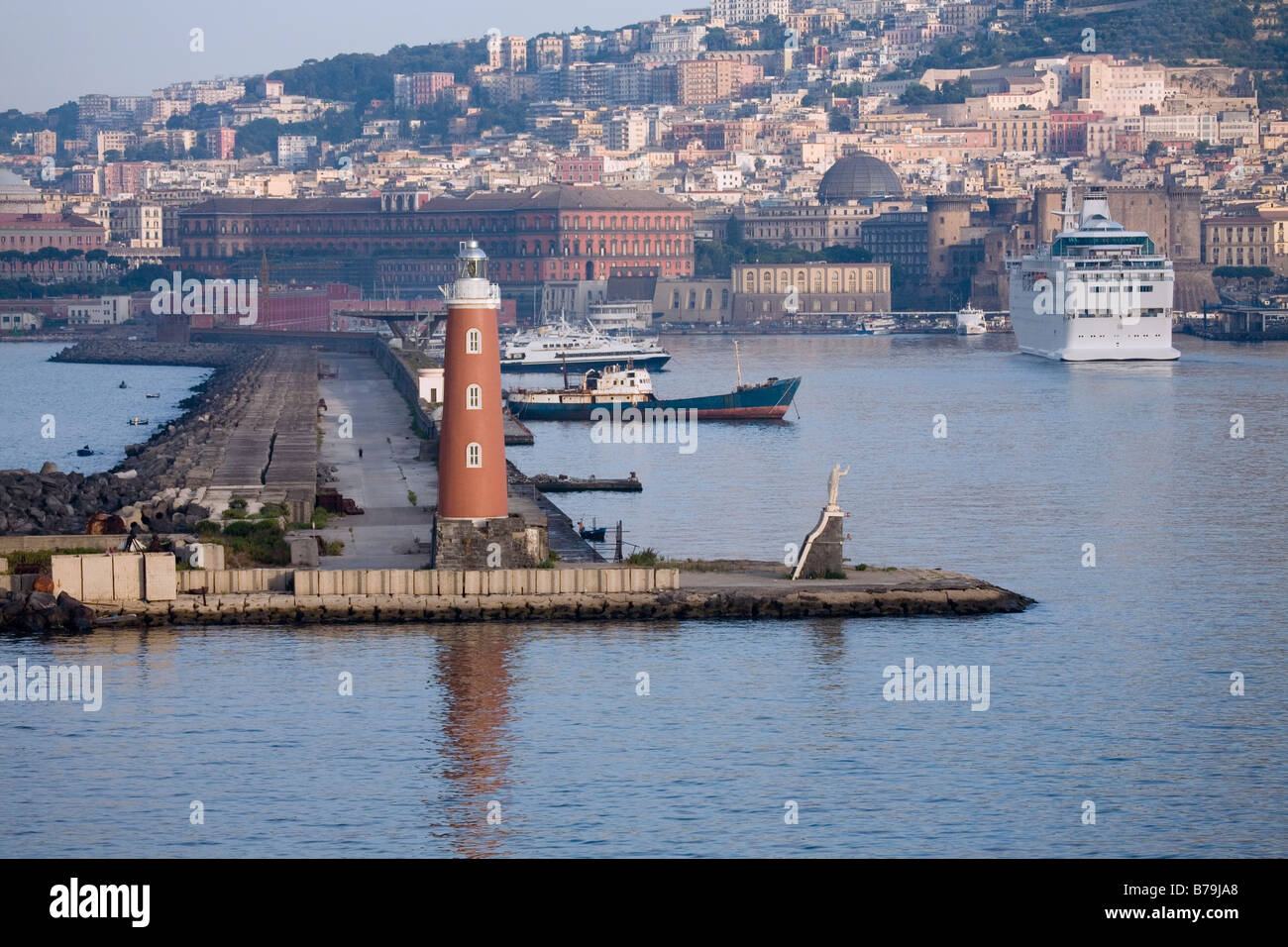 View of the harbour in Napoli Italy with lighthouse and statue seen ...