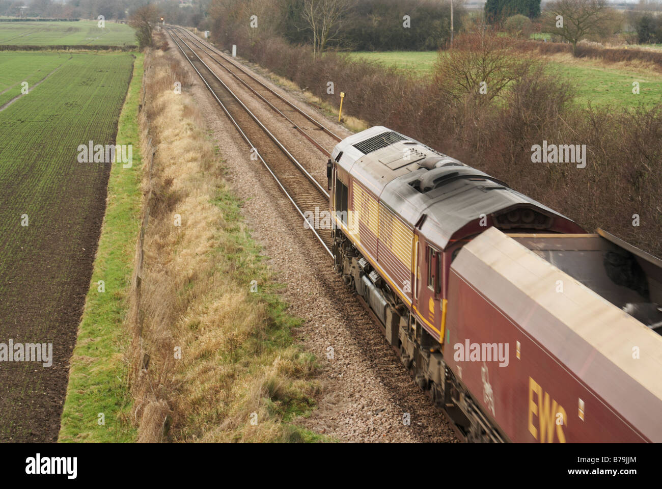 EWS DB Schenker freight train passing Swarkestone Derbyshire heading toward Burton on Trent pulling empty coal wagons Stock Photo