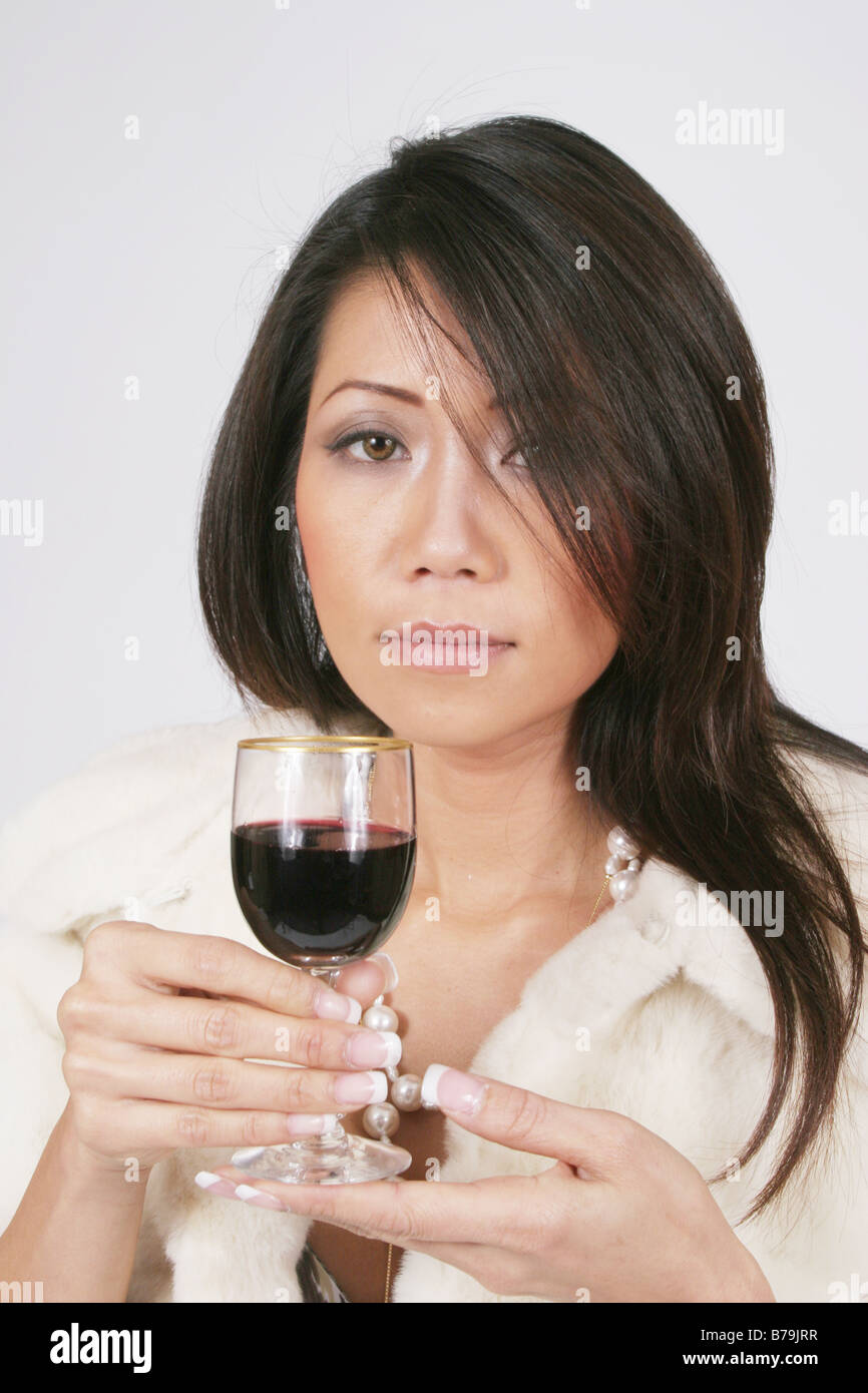 Pretty Asian woman with red wine Stock Photo - Alamy