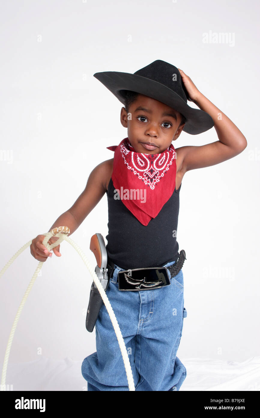African American boy in cowboy outfit, with bandanna and rope