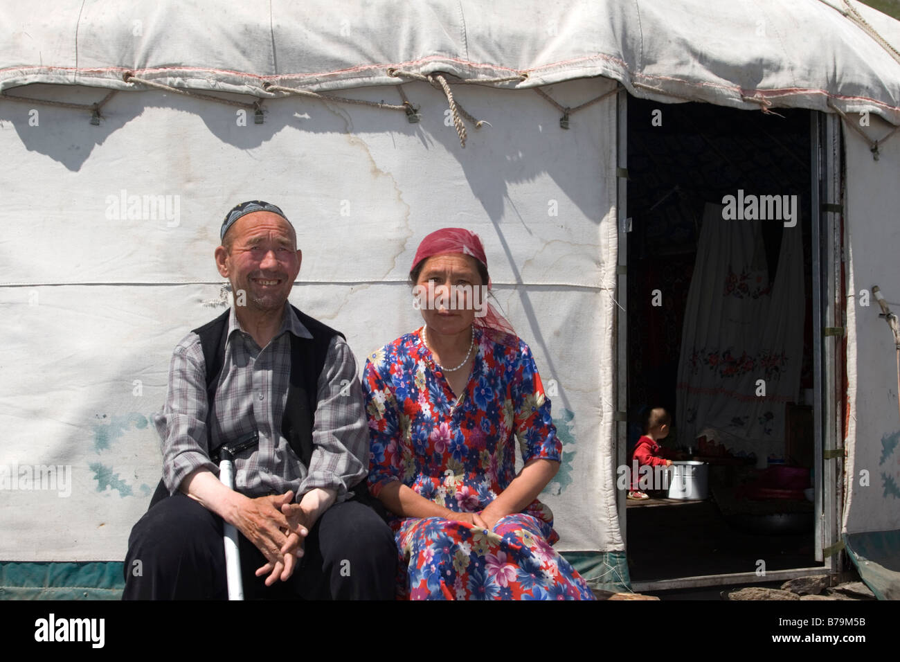 A family sitting outside their yurt home Stock Photo - Alamy