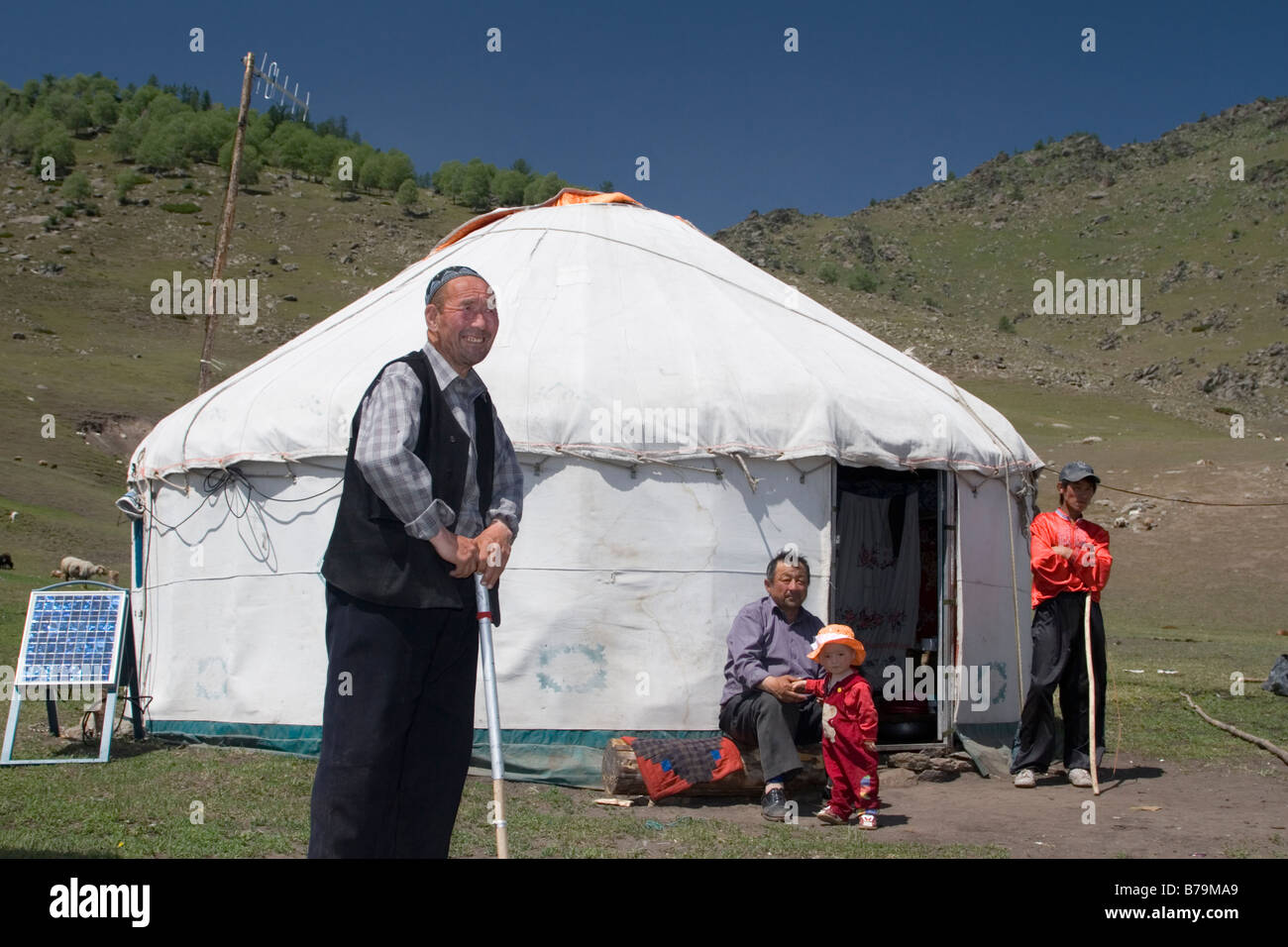 A family of Kazakh herders outside their yurt home. Stock Photo