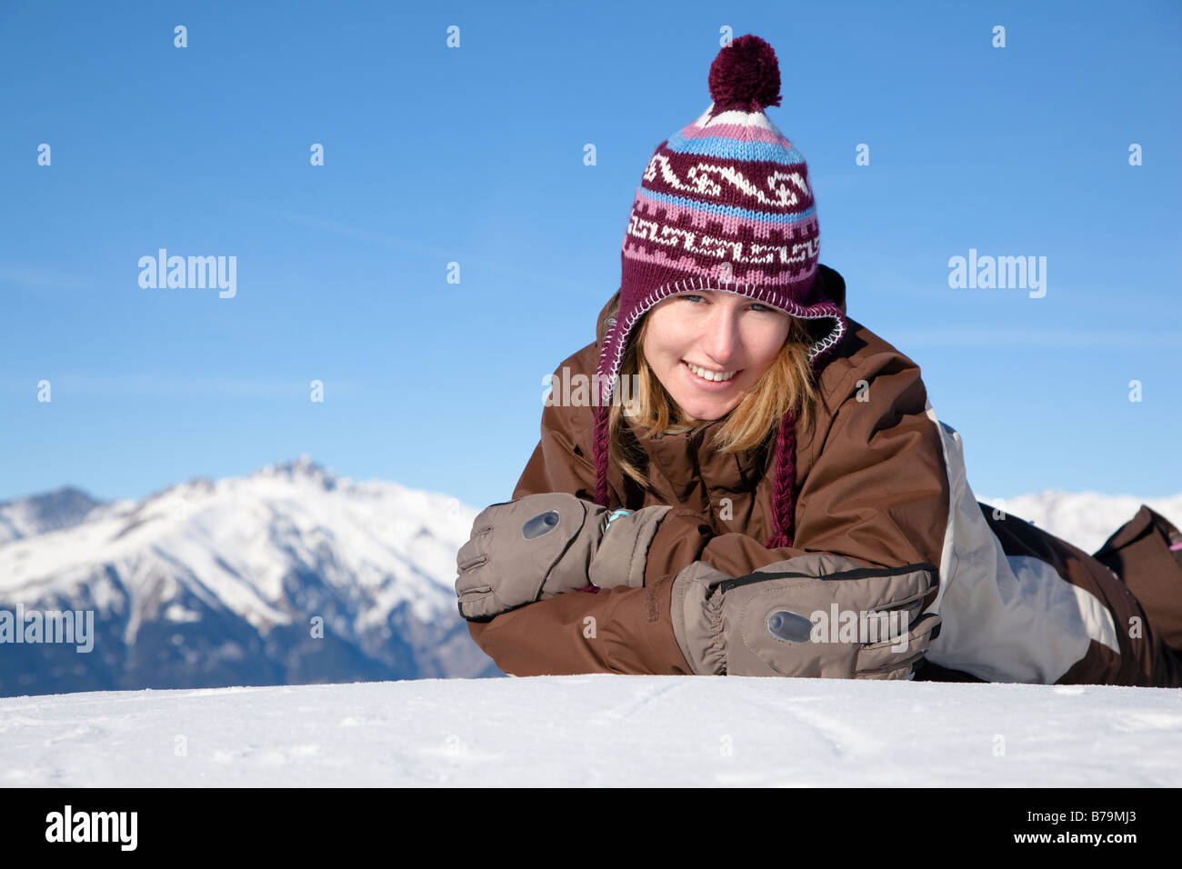 Young woman lying down on snow Copy space Stock Photo