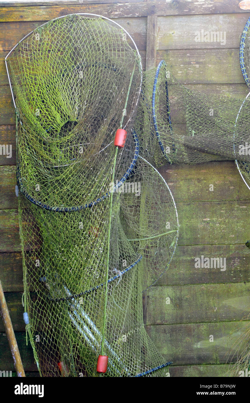 a collection selection of fishing nets hung out to dry on the side of a
