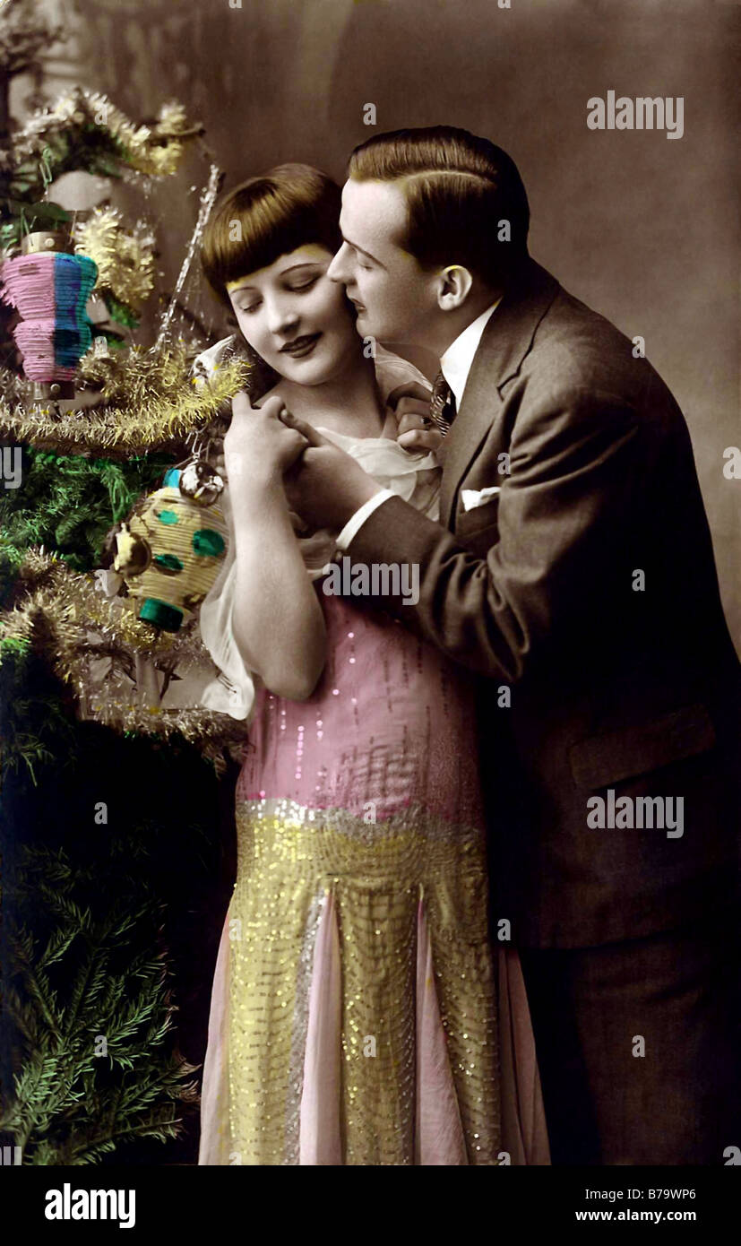Tender embrace under the christmas tree and kissing Stock Photo