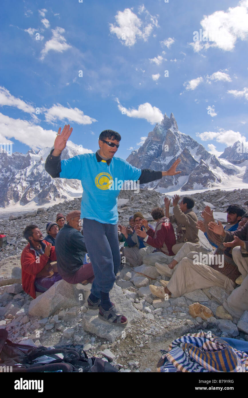 A Pakistani man during a Balti folk dance on the Biafo Glacier in the Karakoram mountains of Pakistan Stock Photo